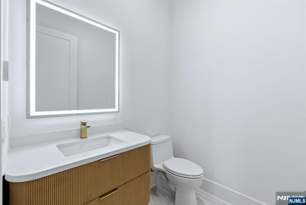 12 Irene Court Demarest, NJ 07627 - Photo 17 of 49 a bathroom with a sink a toilet and a mirror
