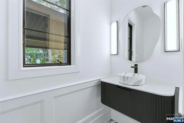 a bathroom with a sink vanity and a mirror