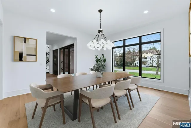 a dining room with furniture a chandelier and wooden floor