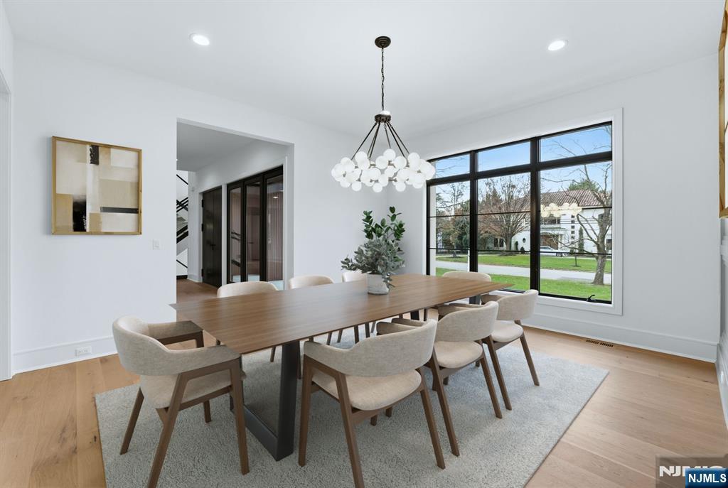 12 Irene Court Demarest, NJ 07627 - Photo 23 of 49 a dining room with furniture a chandelier and wooden floor