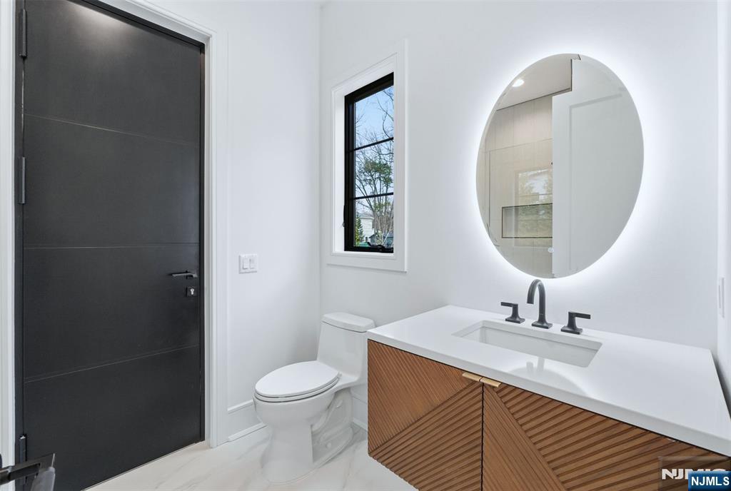 12 Irene Court Demarest, NJ 07627 - Photo 25 of 49 a bathroom with a toilet a sink and a mirror