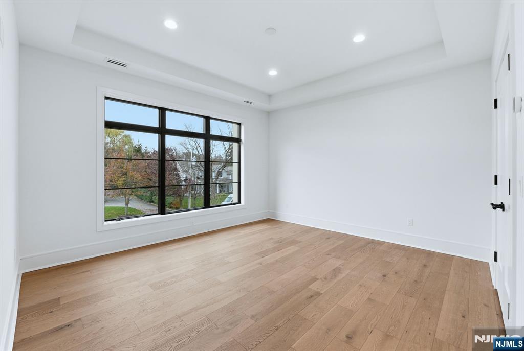 12 Irene Court Demarest, NJ 07627 - Photo 29 of 49 wooden floor in an empty room with a window