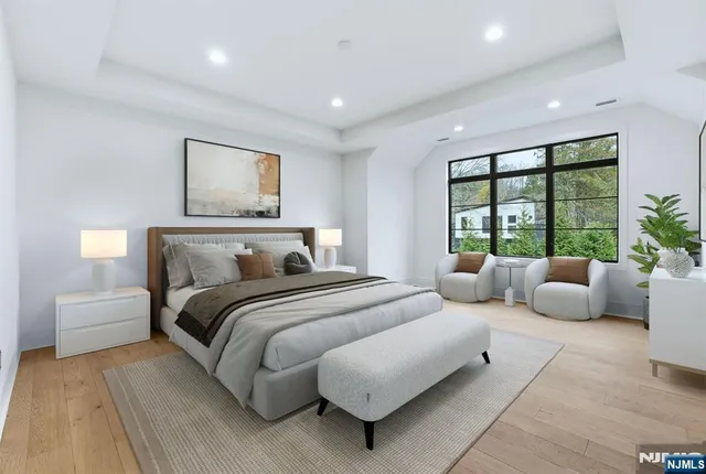 a bedroom with a large bed and a large window