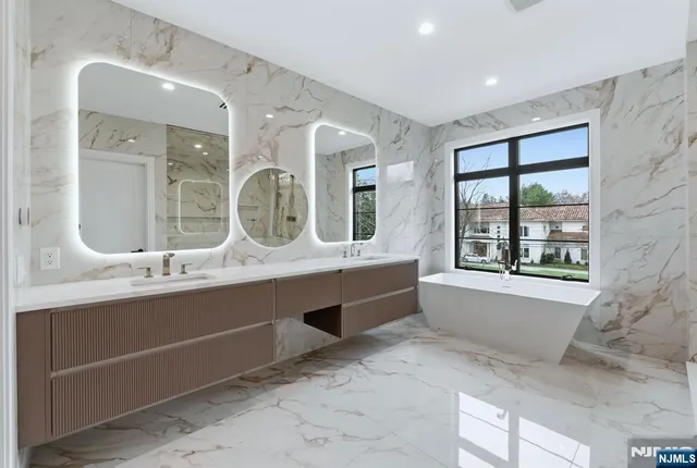 a large bathroom with a large tub and sink