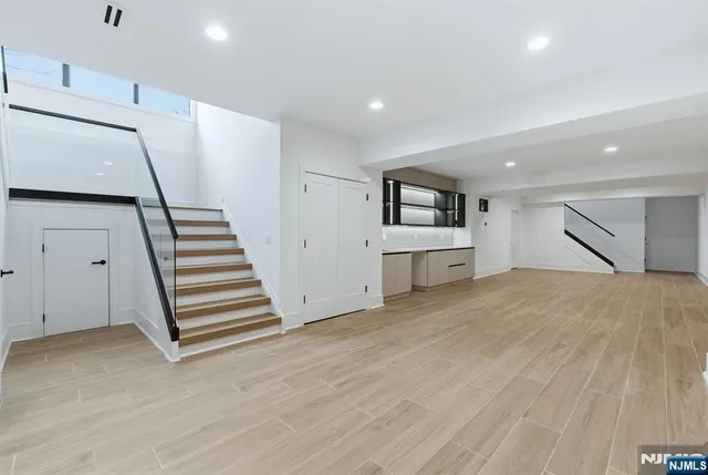 a view of a room with wooden floor and stairs