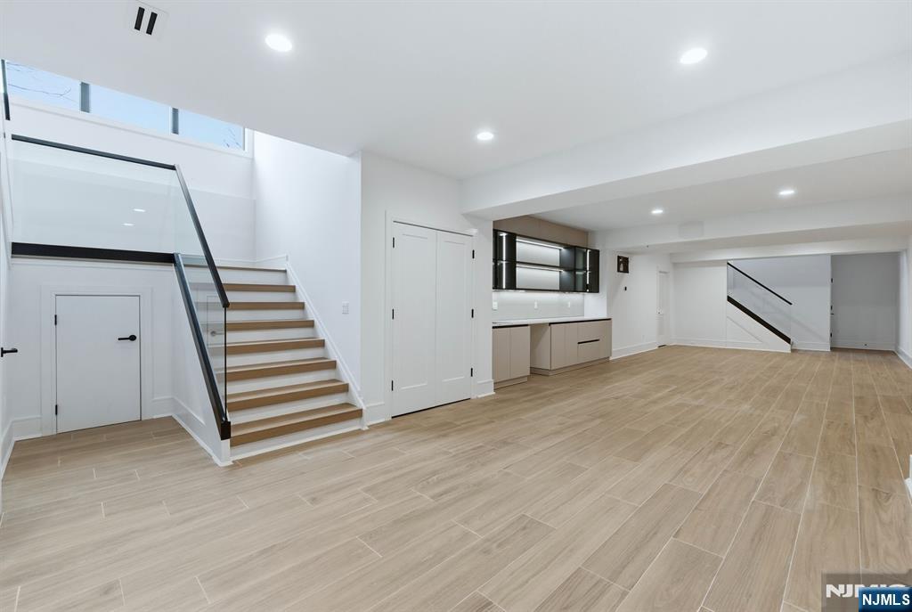 12 Irene Court Demarest, NJ 07627 - Photo 41 of 49 a view of a room with wooden floor and stairs