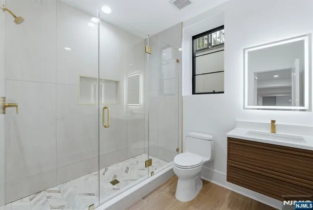 a bathroom with a sink toilet and shower
