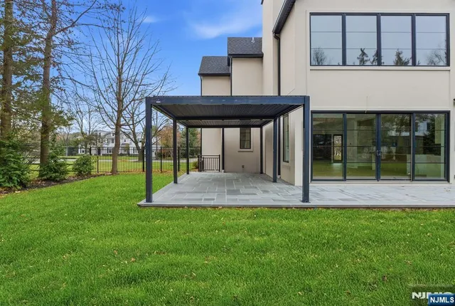 a view of a house with a yard and tree