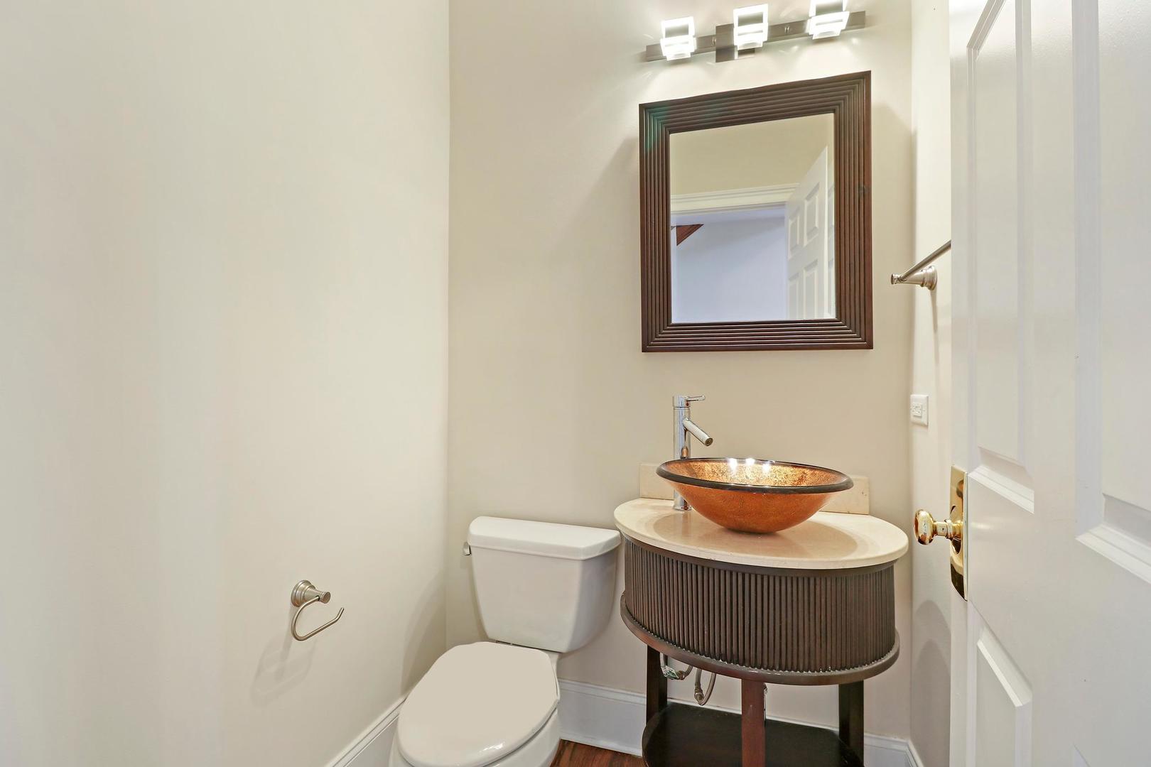 807 Poplar Court Inverness, IL 60010 - Photo 18 of 49 a bathroom with a toilet a sink and mirror