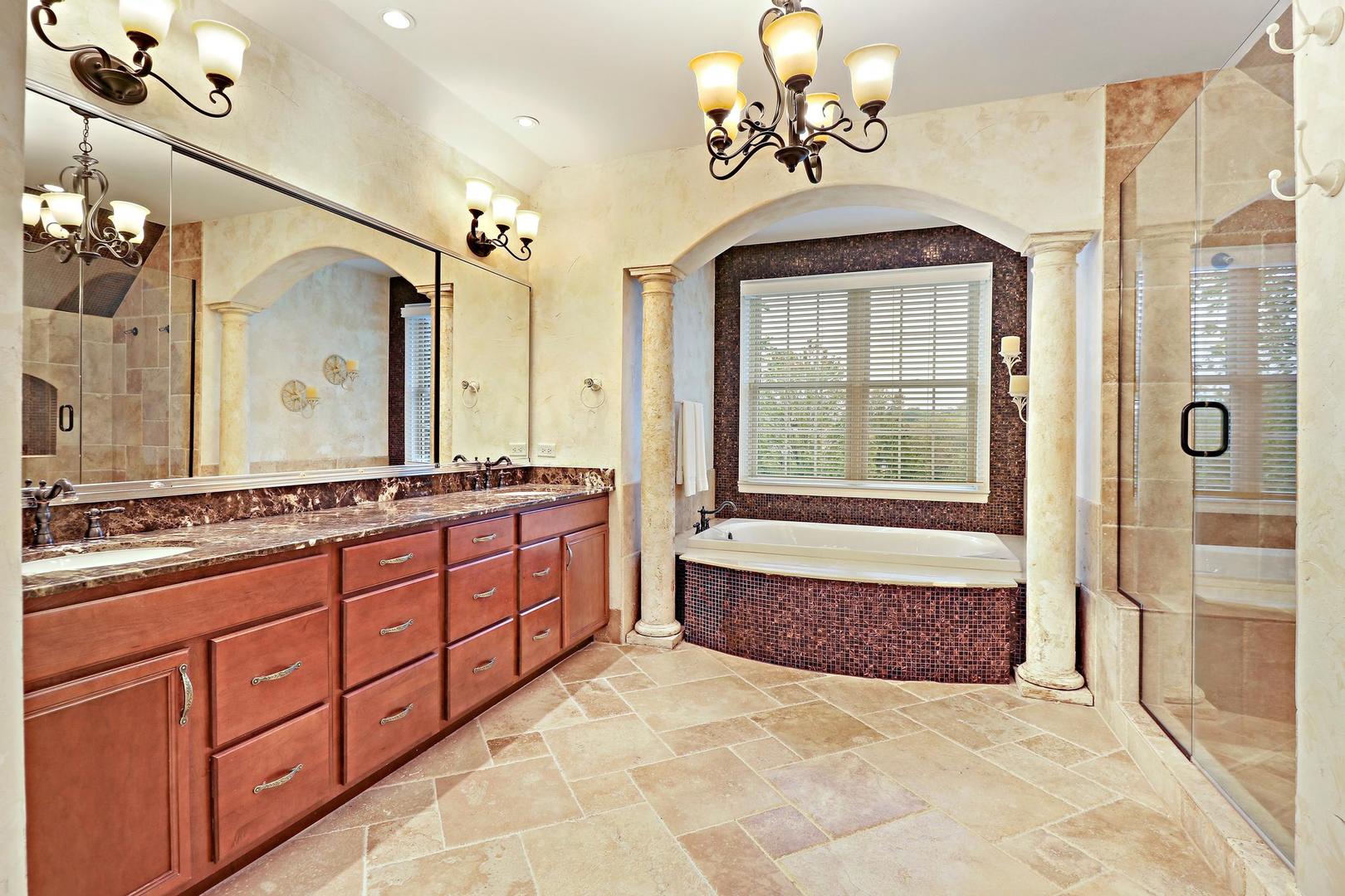 807 Poplar Court Inverness, IL 60010 - Photo 27 of 49 a bathroom with a granite countertop sink a large mirror and a bathtub next to a window