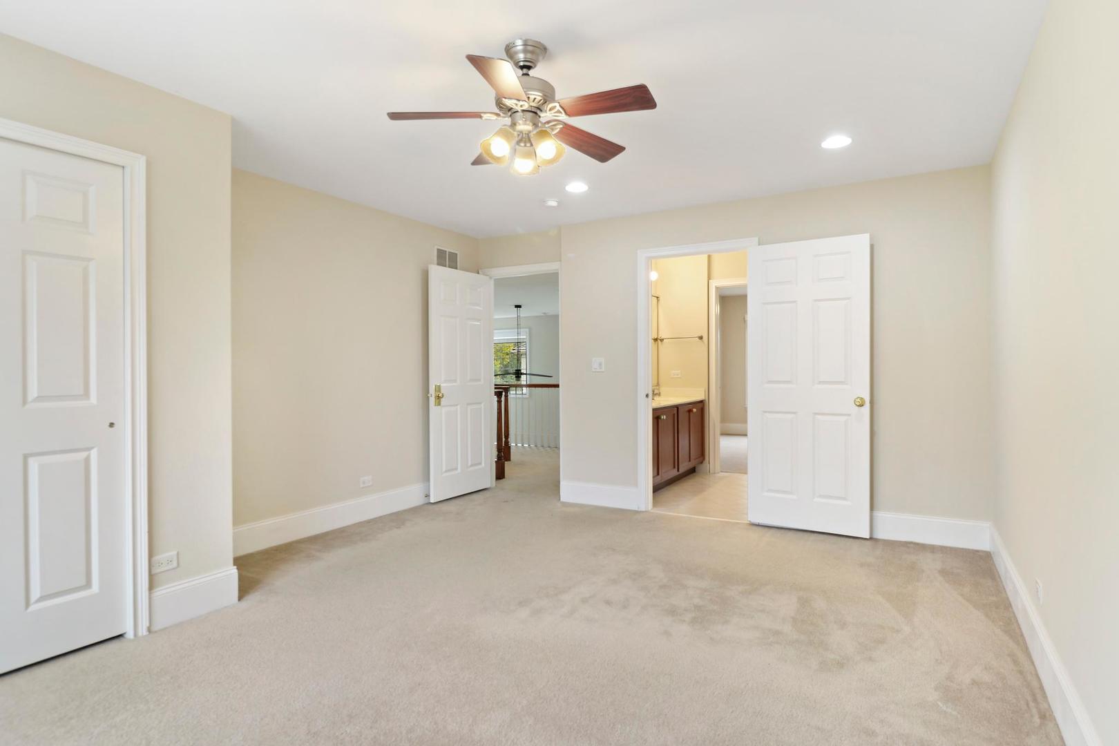 807 Poplar Court Inverness, IL 60010 - Photo 32 of 49 an empty room with closet and a ceiling fan