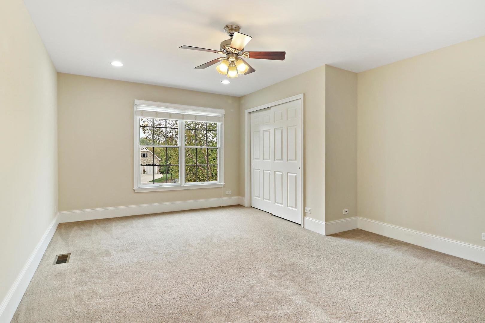 807 Poplar Court Inverness, IL 60010 - Photo 35 of 49 an empty room with windows and chandelier fan