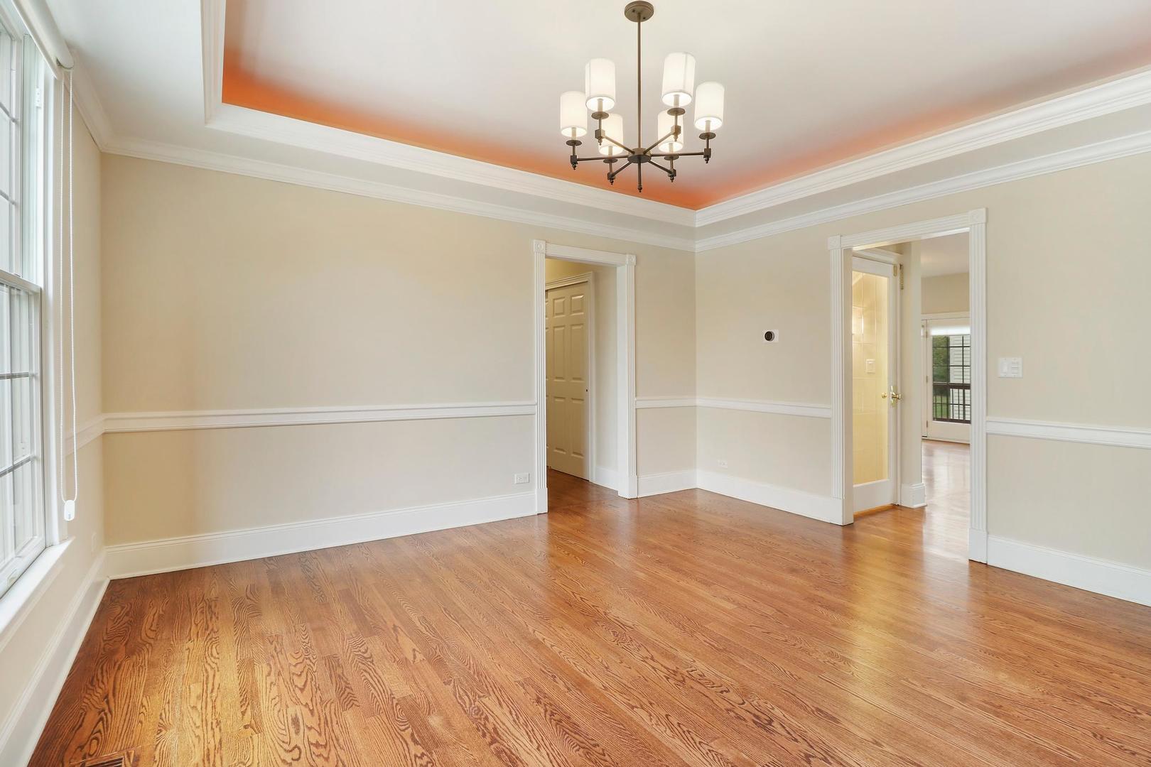807 Poplar Court Inverness, IL 60010 - Photo 9 of 49 a view of a livingroom with wooden floor staircase and a kitchen space
