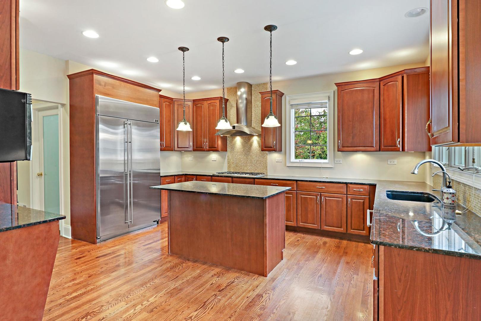 807 Poplar Court Inverness, IL 60010 - Photo 10 of 49 a open kitchen with stainless steel appliances granite countertop a sink a stove and a wooden floors