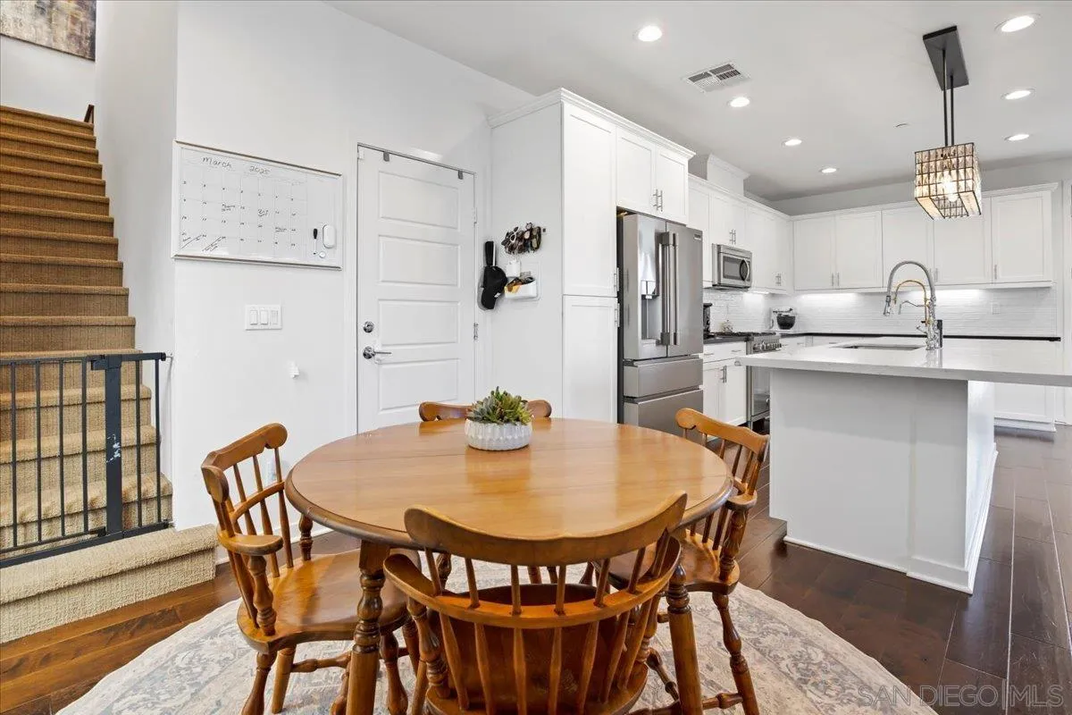 2123 Element Way Chula Vista, CA 91915 - Photo 19 of 42 a dining room with stainless steel appliances a dining table and chairs