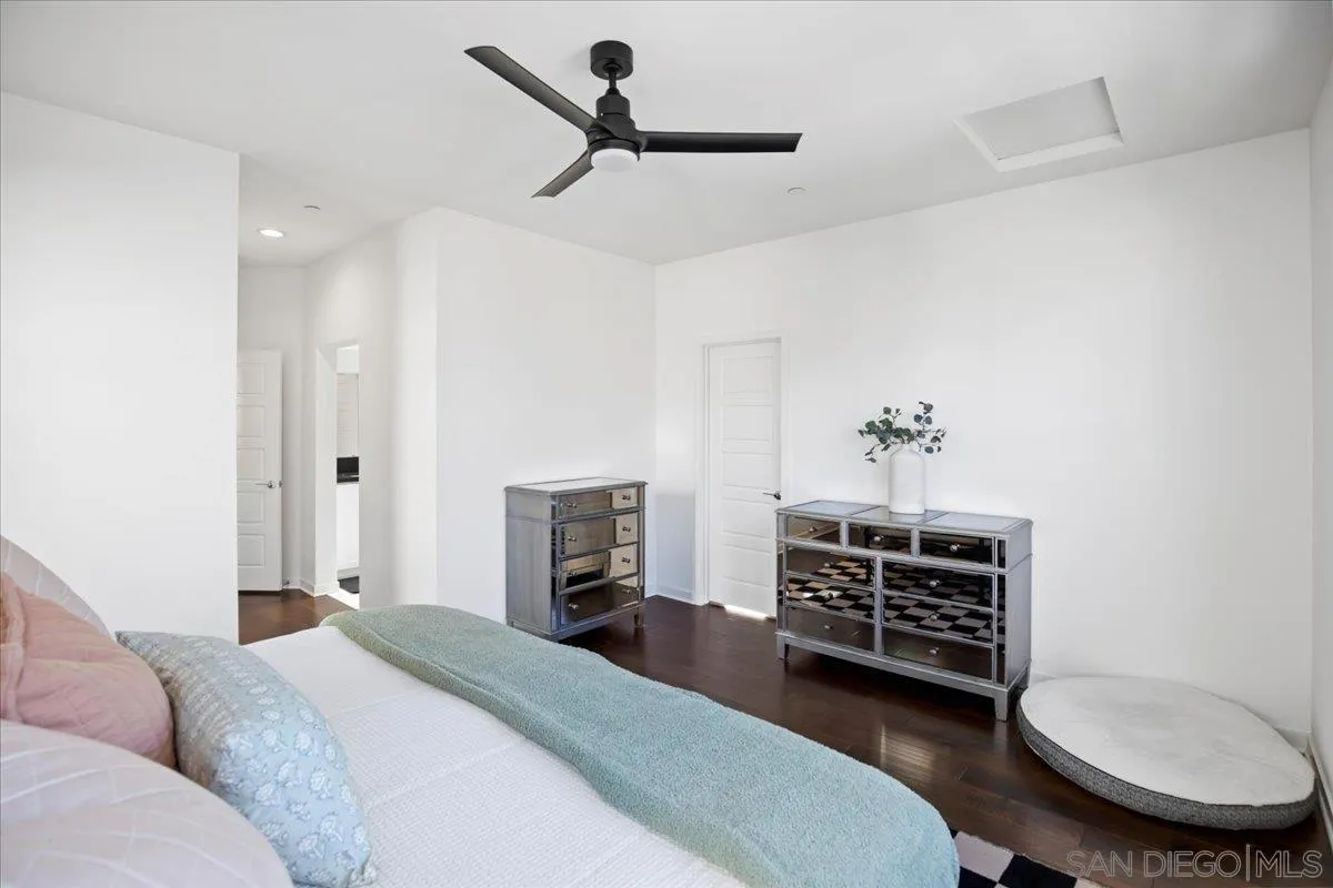 2123 Element Way Chula Vista, CA 91915 - Photo 26 of 42 a spacious bedroom with a bed a dresser and a chandelier