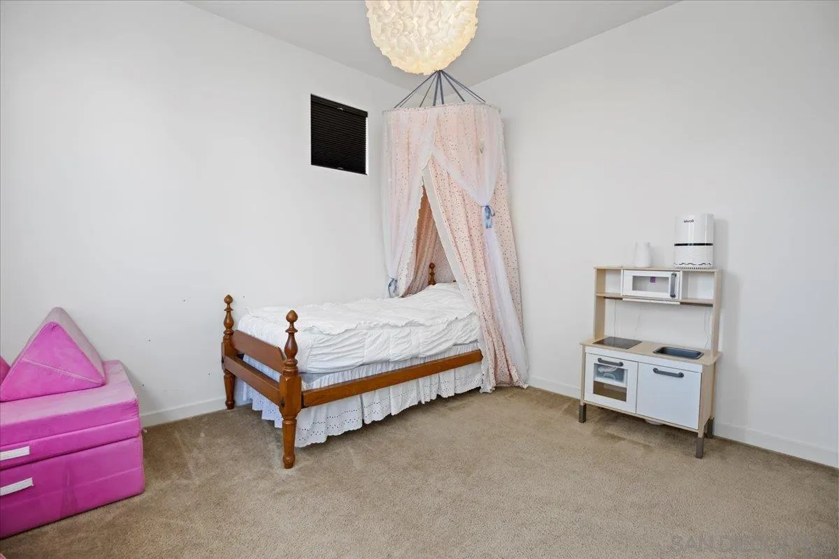 2123 Element Way Chula Vista, CA 91915 - Photo 30 of 42 a bedroom with a bed and a chandelier
