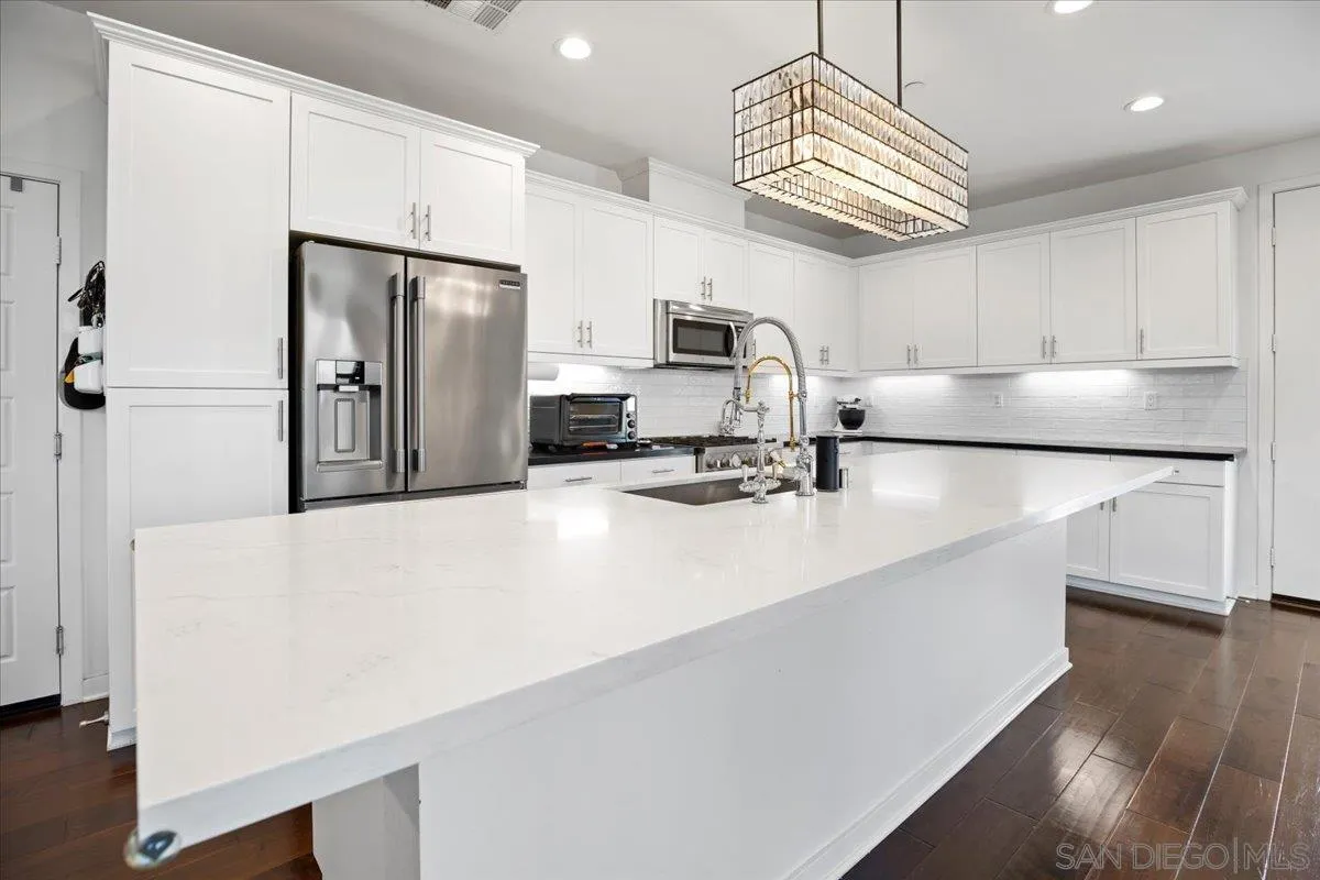 2123 Element Way Chula Vista, CA 91915 - Photo 7 of 42 a kitchen with stainless steel appliances a refrigerator sink and microwave