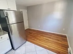 a view of a kitchen with refrigerator and cabinet