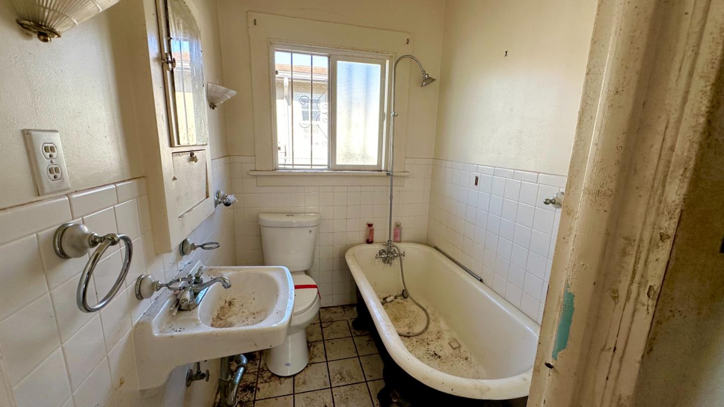 936 Camelia Street Berkeley, CA 94710 - Photo 5 of 9 a bathroom with a sink a toilet and a mirror