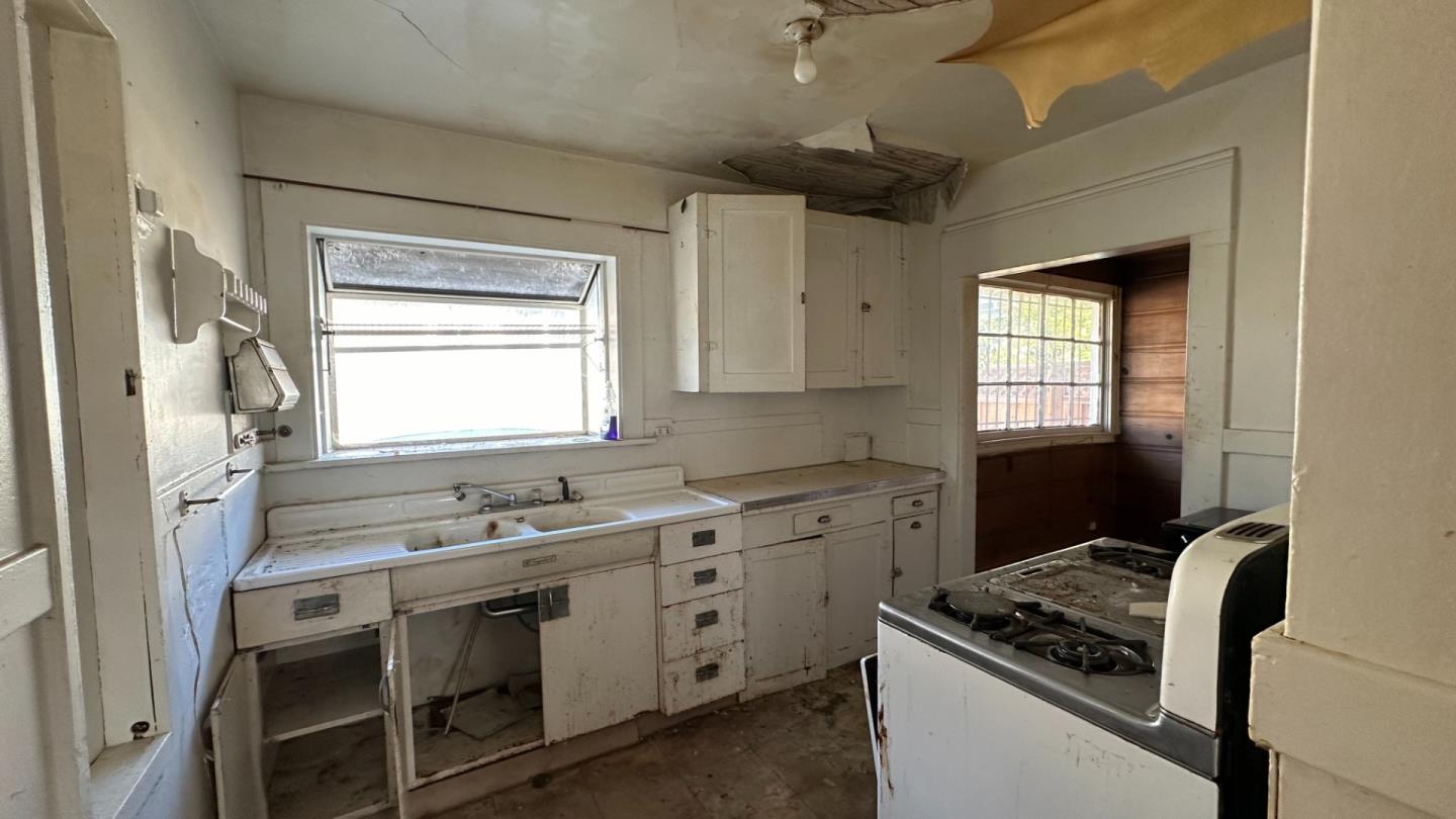 936 Camelia Street Berkeley, CA 94710 - Photo 6 of 9 a kitchen with cabinets appliances and a window