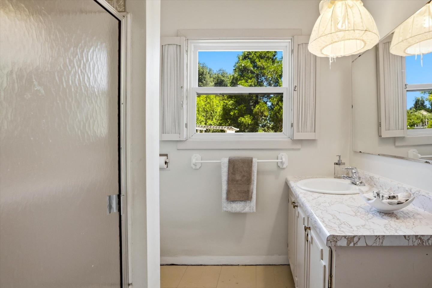 16899 Kennedy Road Los Gatos, CA 95032 - Photo 50 of 61 a bathroom with a granite countertop sink and a window