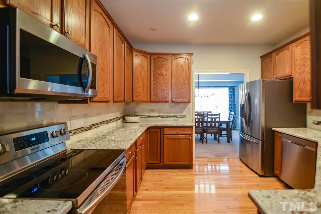 A chef's dream kitchen features granite countertops, plenty of cabinets for storage and hardwood floors!  Preparing holiday meals will be a breeze!`