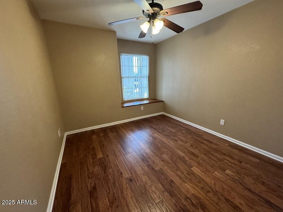 3124 East Piute Avenue Phoenix, AZ 85050 - Photo 13 of 25 a view of an empty room with wooden floor and a window