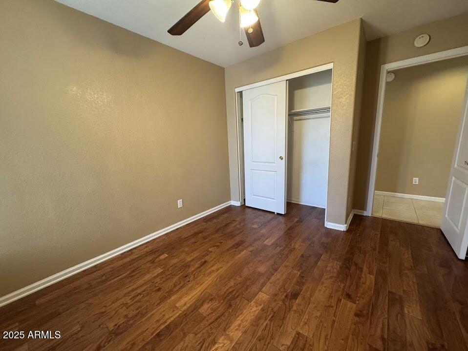 3124 East Piute Avenue Phoenix, AZ 85050 - Photo 14 of 25 an empty room with wooden floor and closet area