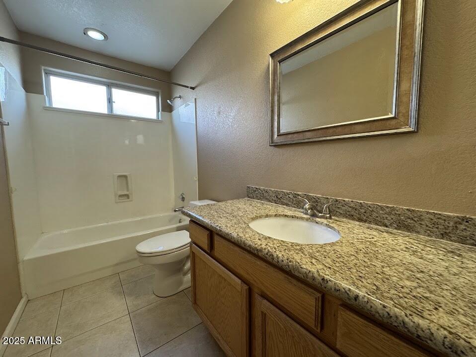 3124 East Piute Avenue Phoenix, AZ 85050 - Photo 17 of 25 a bathroom with a granite countertop sink a toilet a mirror and bathtub