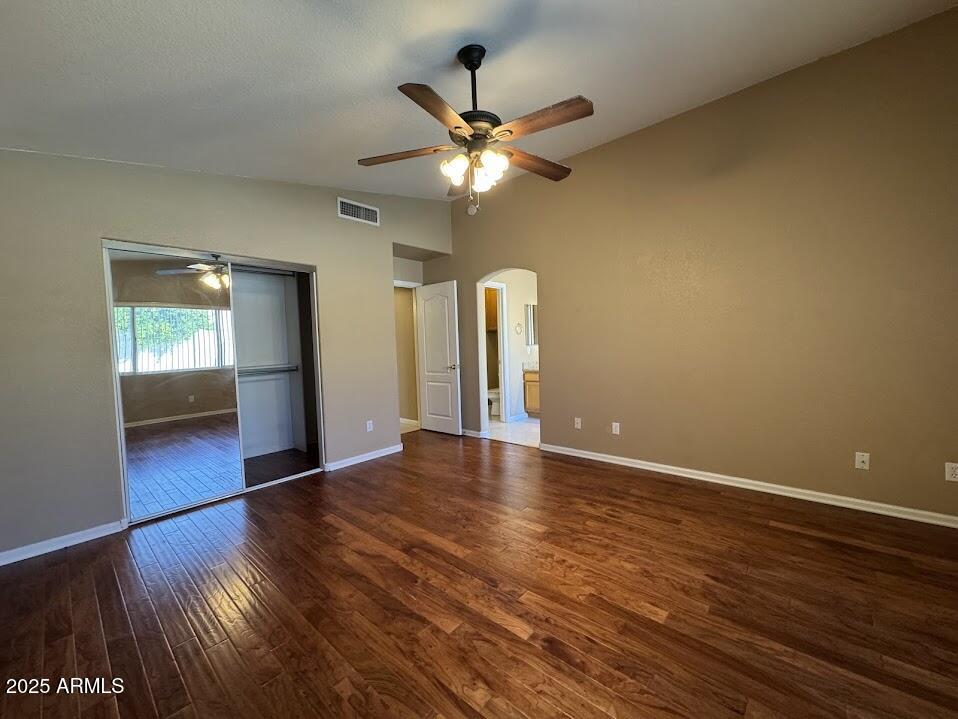 3124 East Piute Avenue Phoenix, AZ 85050 - Photo 19 of 25 a view of an empty room with wooden floor and a ceiling fan