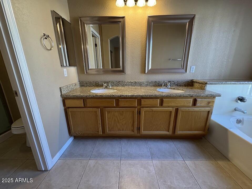 3124 East Piute Avenue Phoenix, AZ 85050 - Photo 20 of 25 a bathroom with a sink a mirror and a vanity