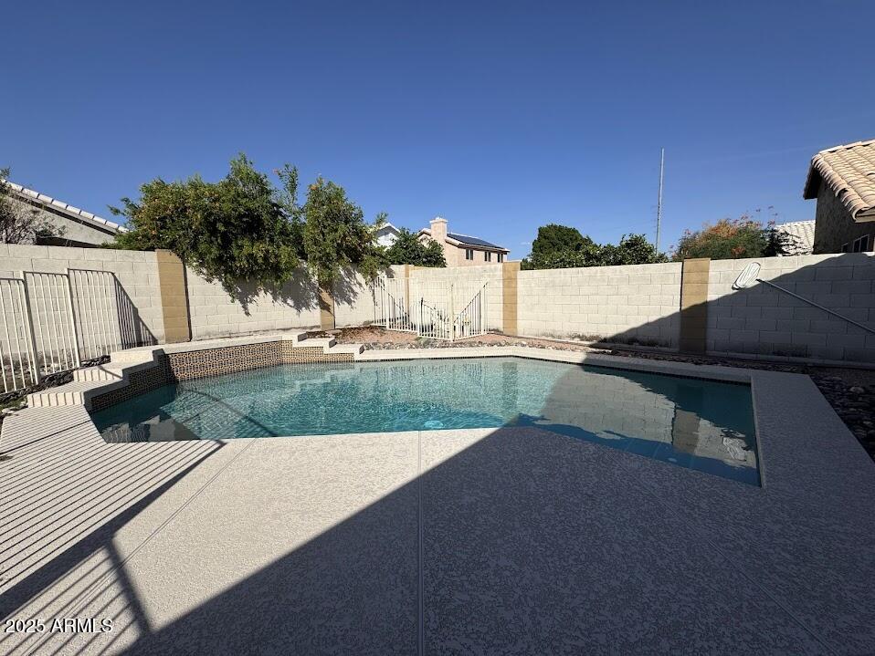 3124 East Piute Avenue Phoenix, AZ 85050 - Photo 24 of 25 a view of yellow house with swimming pool