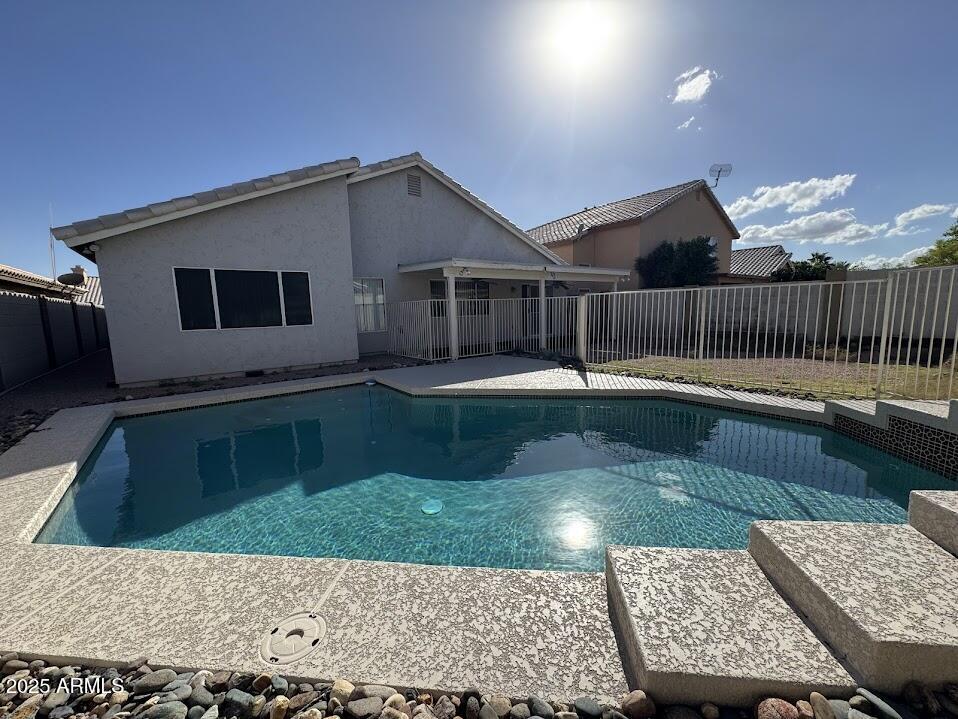 3124 East Piute Avenue Phoenix, AZ 85050 - Photo 25 of 25 a backyard of a house with table chairs and a yard