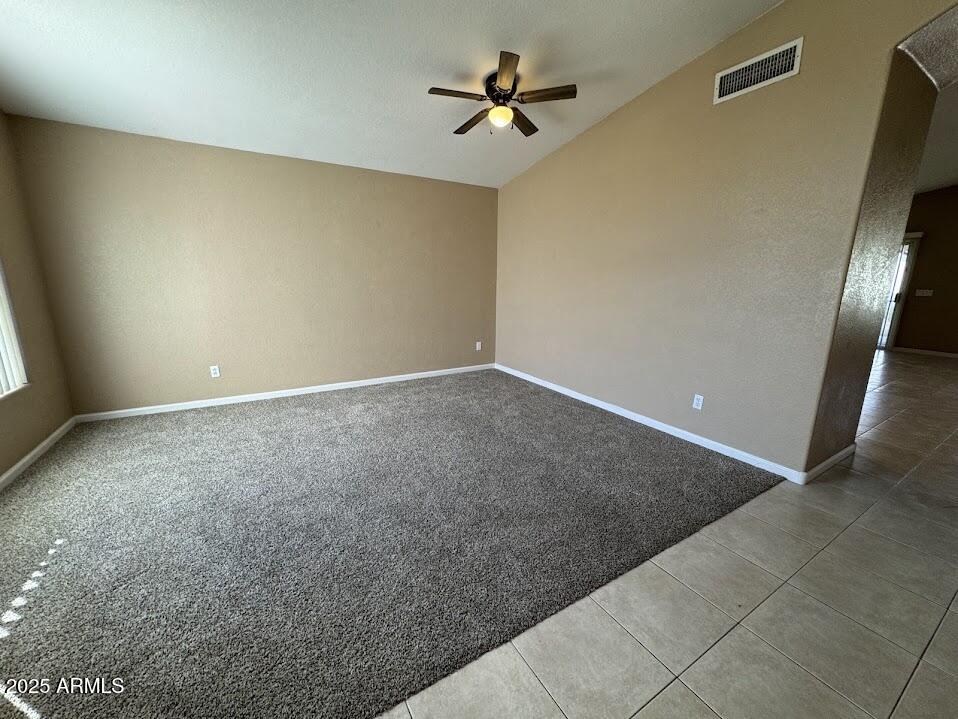 3124 East Piute Avenue Phoenix, AZ 85050 - Photo 5 of 25 an empty room with a chandelier fan and windows
