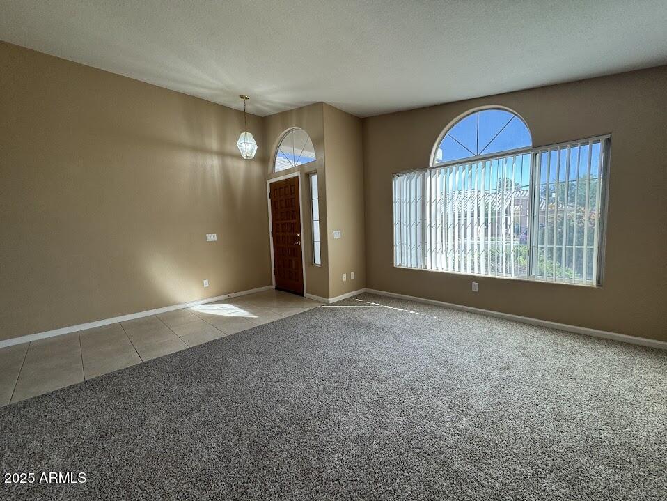 3124 East Piute Avenue Phoenix, AZ 85050 - Photo 6 of 25 an empty room with a fan and windows