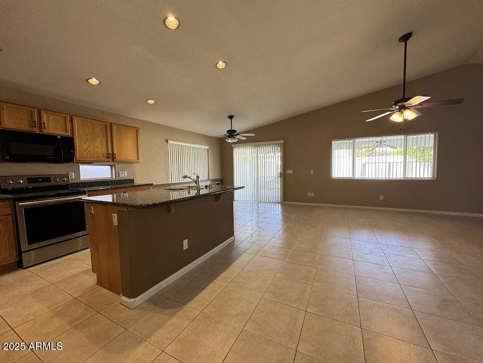 3124 East Piute Avenue Phoenix, AZ 85050 - Photo 7 of 25 a kitchen with stainless steel appliances granite countertop a stove a sink and a refrigerator