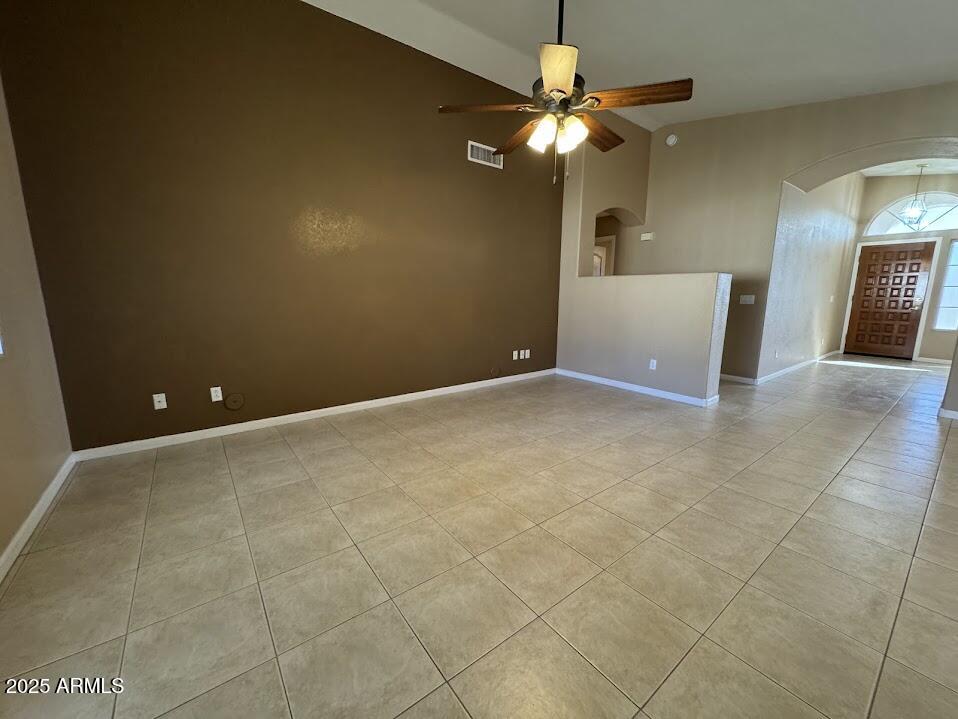 3124 East Piute Avenue Phoenix, AZ 85050 - Photo 9 of 25 an empty room with a chandelier fan and windows