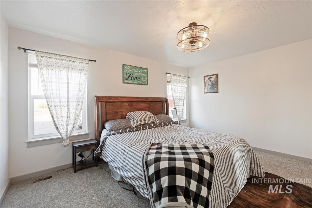 17571 Goodson Road Caldwell, ID 83607 - Photo 11 of 36 Bedroom with carpet and baseboards