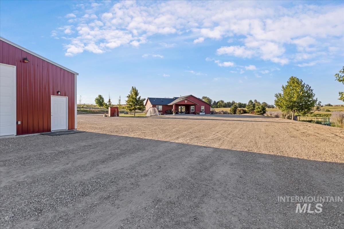 17571 Goodson Road Caldwell, ID 83607 - Photo 24 of 36 View of yard featuring an outdoor structure and a detached garage