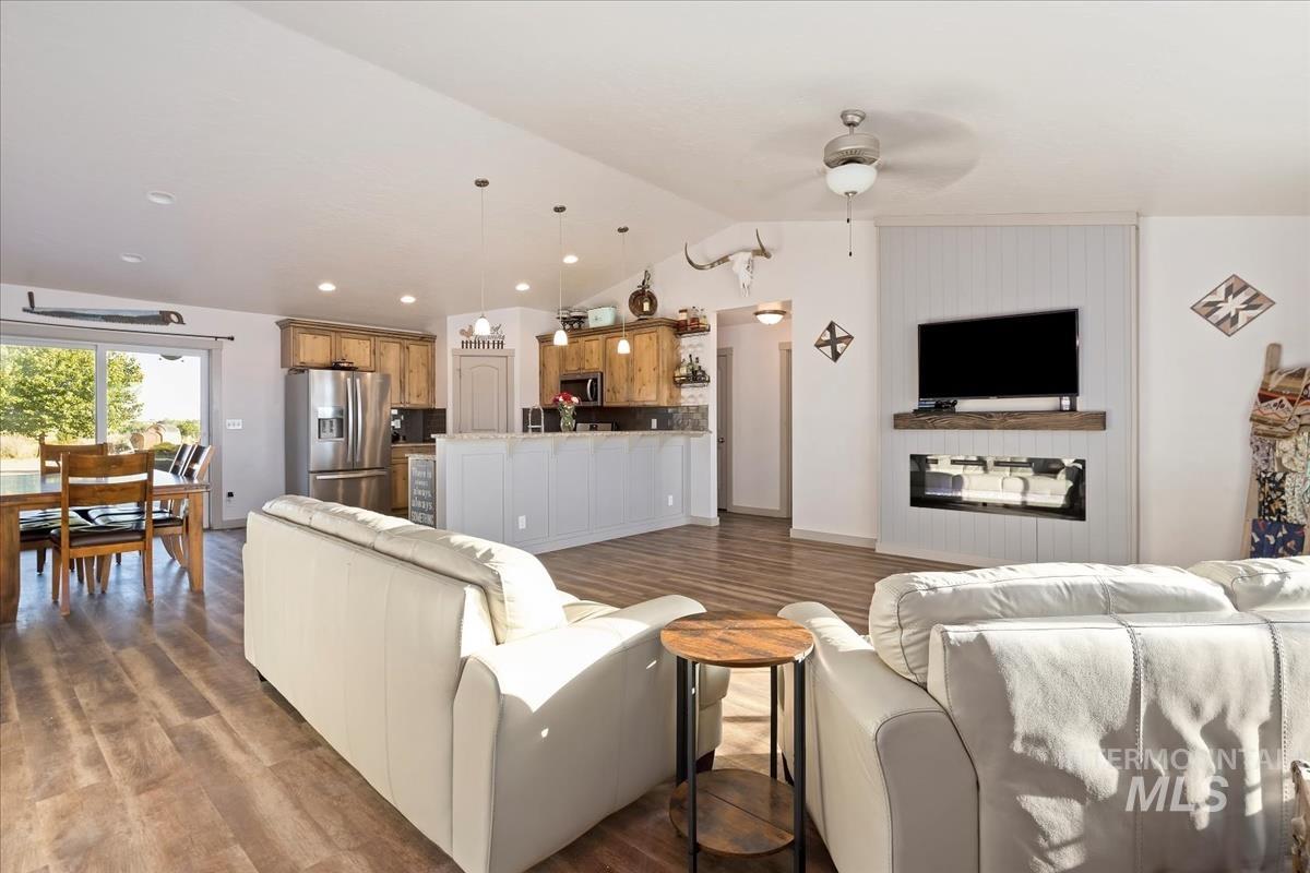 17571 Goodson Road Caldwell, ID 83607 - Photo 4 of 36 Living room featuring dark wood finished floors, vaulted ceiling, ceiling fan, and recessed lighting