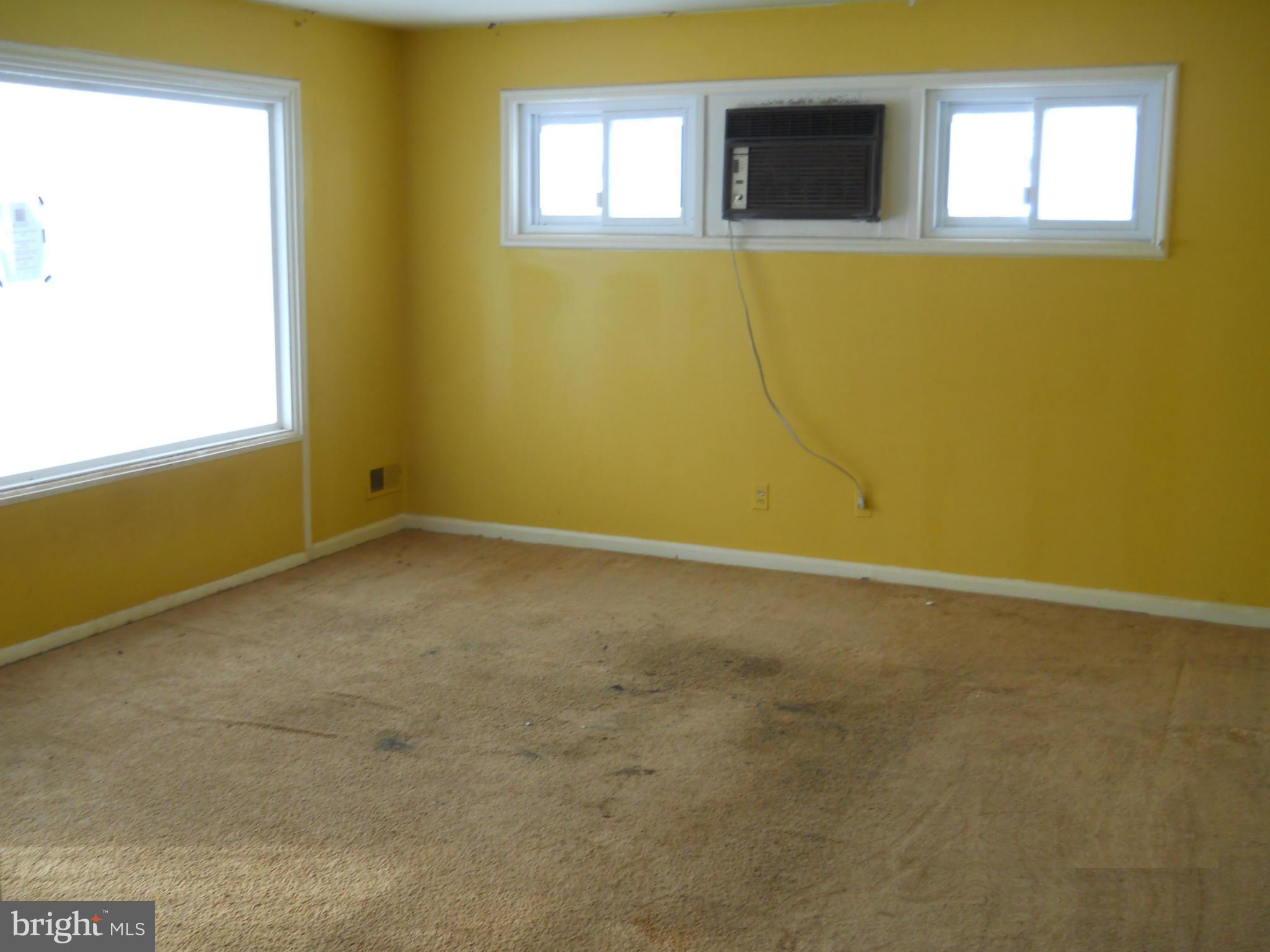 7506 Rockridge Road Baltimore, MD 21208 - Photo 3 of 12 a view of an empty room with a window