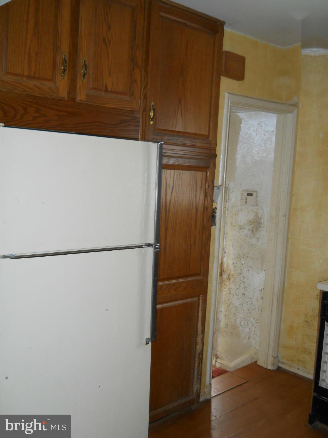 7506 Rockridge Road Baltimore, MD 21208 - Photo 5 of 12 a white refrigerator freezer sitting in a kitchen