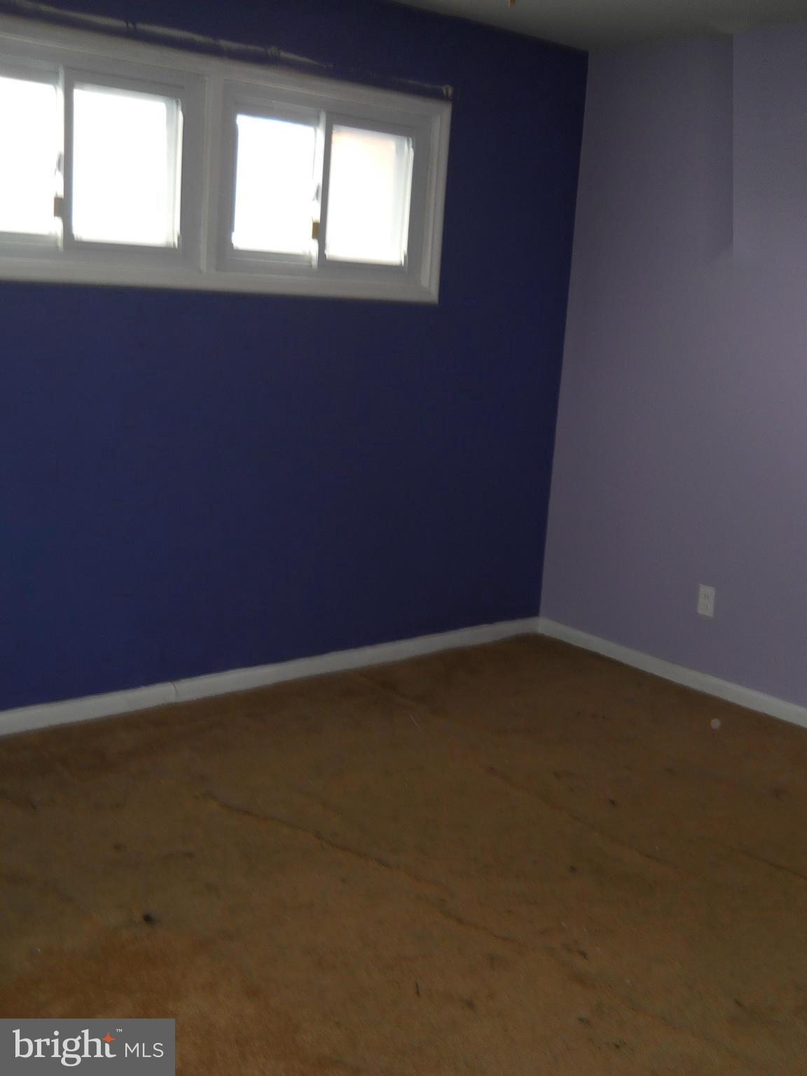7506 Rockridge Road Baltimore, MD 21208 - Photo 7 of 12 a view of an empty room with a window
