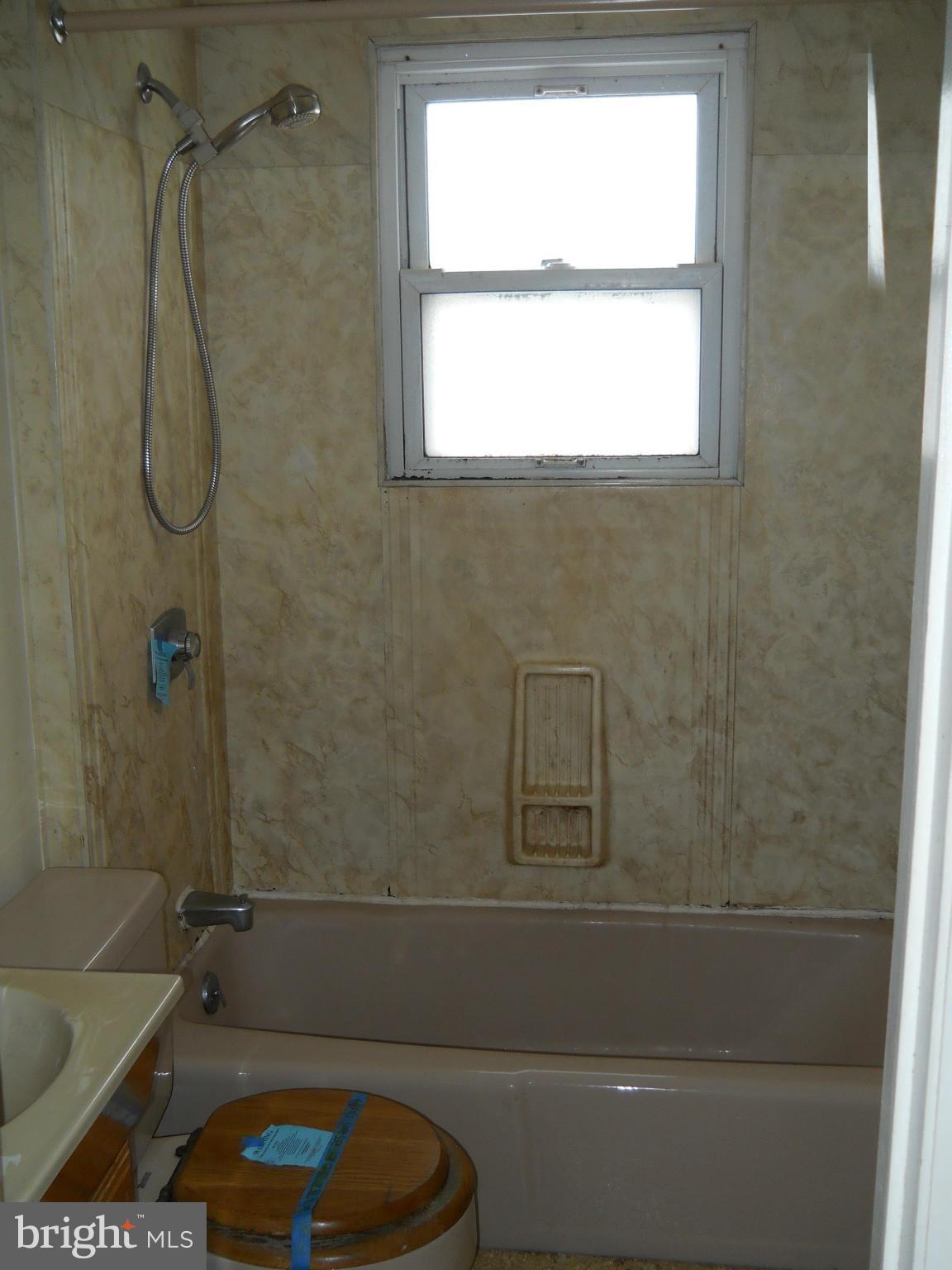 7506 Rockridge Road Baltimore, MD 21208 - Photo 10 of 12 a bathroom with a shower and a toilet