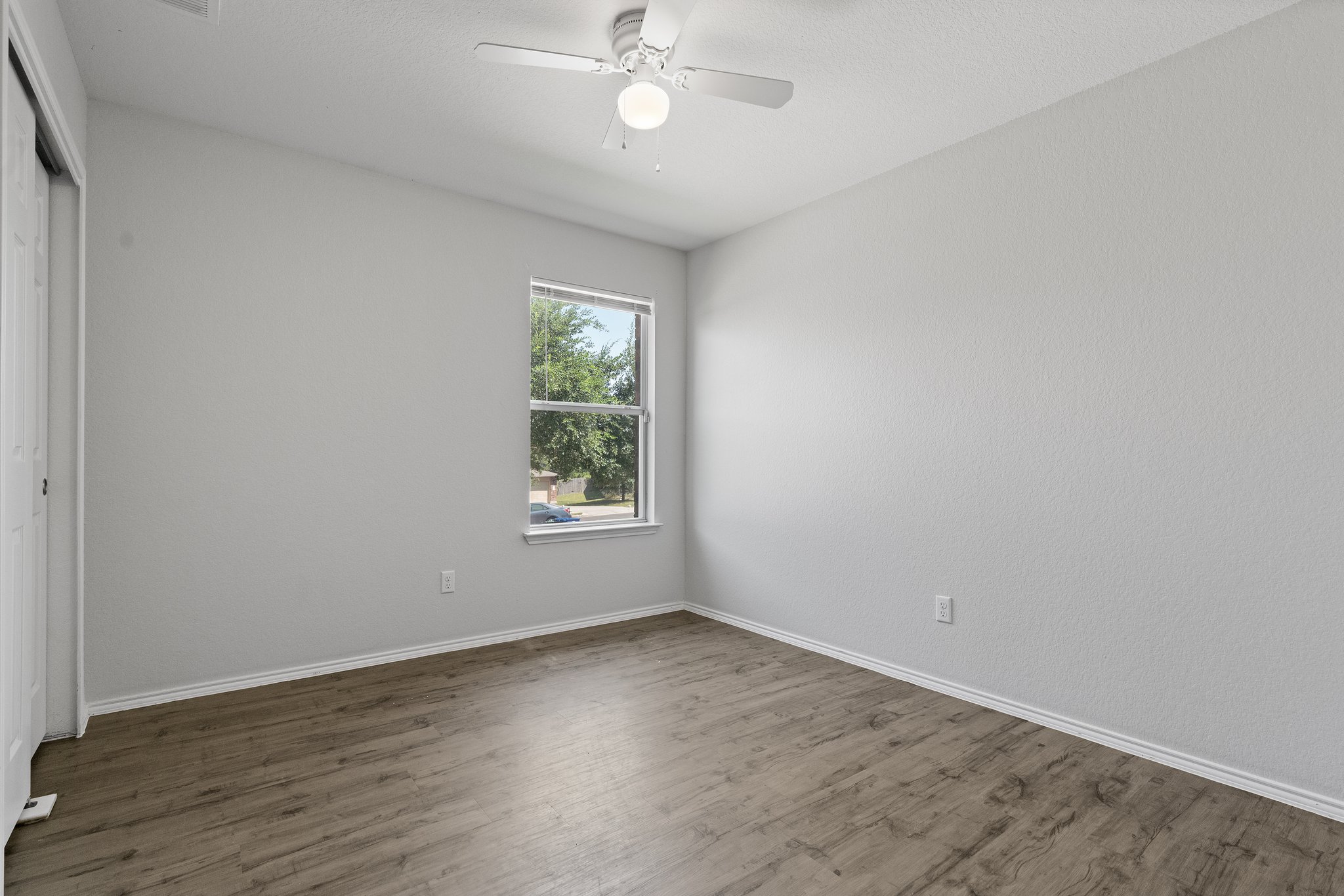 5800 Maciver Drive Austin, TX 78754 - Photo 20 of 27 Unfurnished bedroom featuring a closet, wood finished floors, and a ceiling fan
