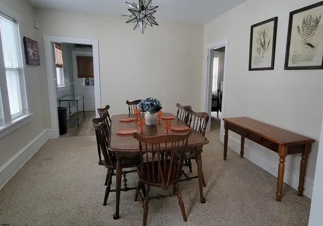 a view of a dining room with furniture and chandelier