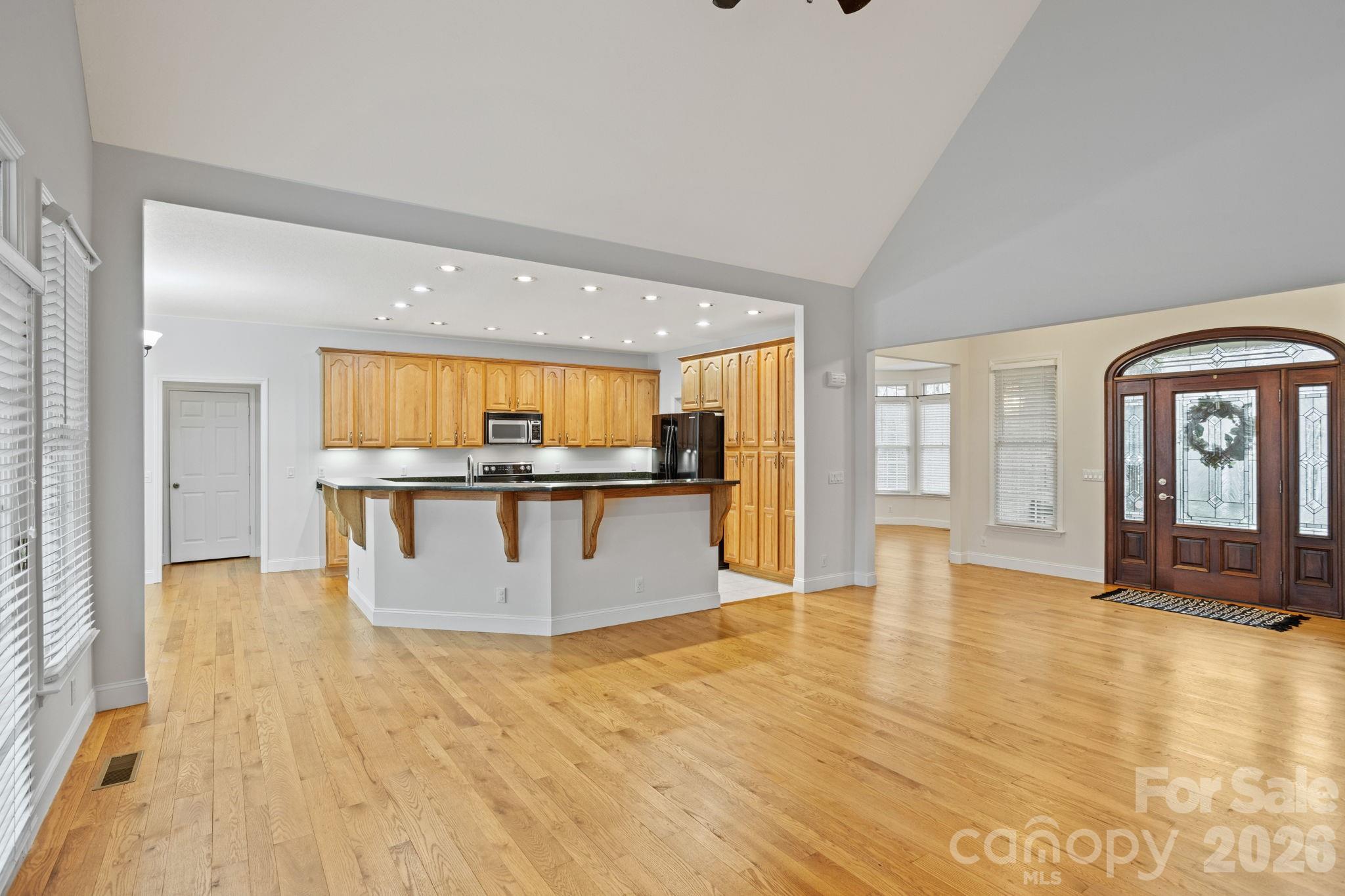 199 Judson Ridge Road Arden, NC 28704 - Photo 13 of 48 a view of a living room with kitchen island granite countertop wooden floor and a rug