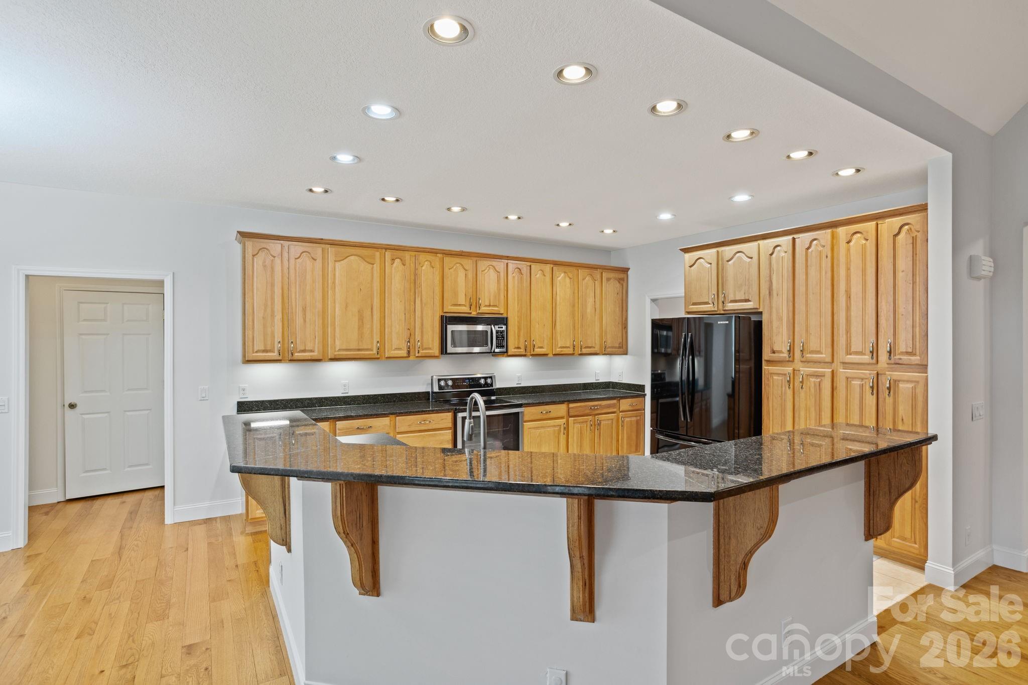 199 Judson Ridge Road Arden, NC 28704 - Photo 14 of 48 a kitchen with stainless steel appliances granite countertop a sink a stove and a refrigerator