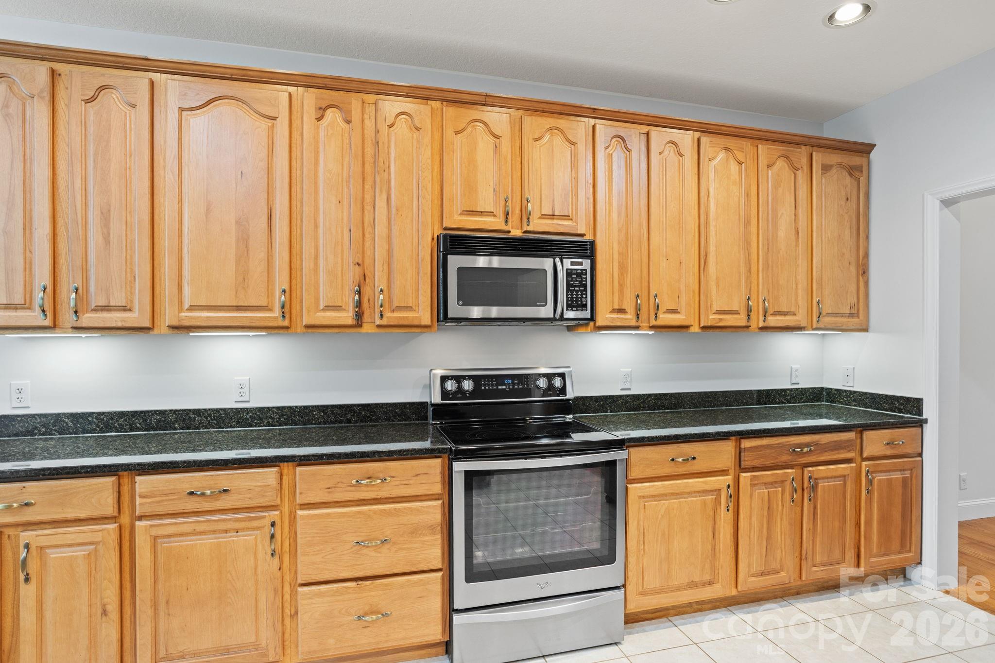 199 Judson Ridge Road Arden, NC 28704 - Photo 18 of 48 a kitchen with granite countertop white cabinets and stainless steel appliances